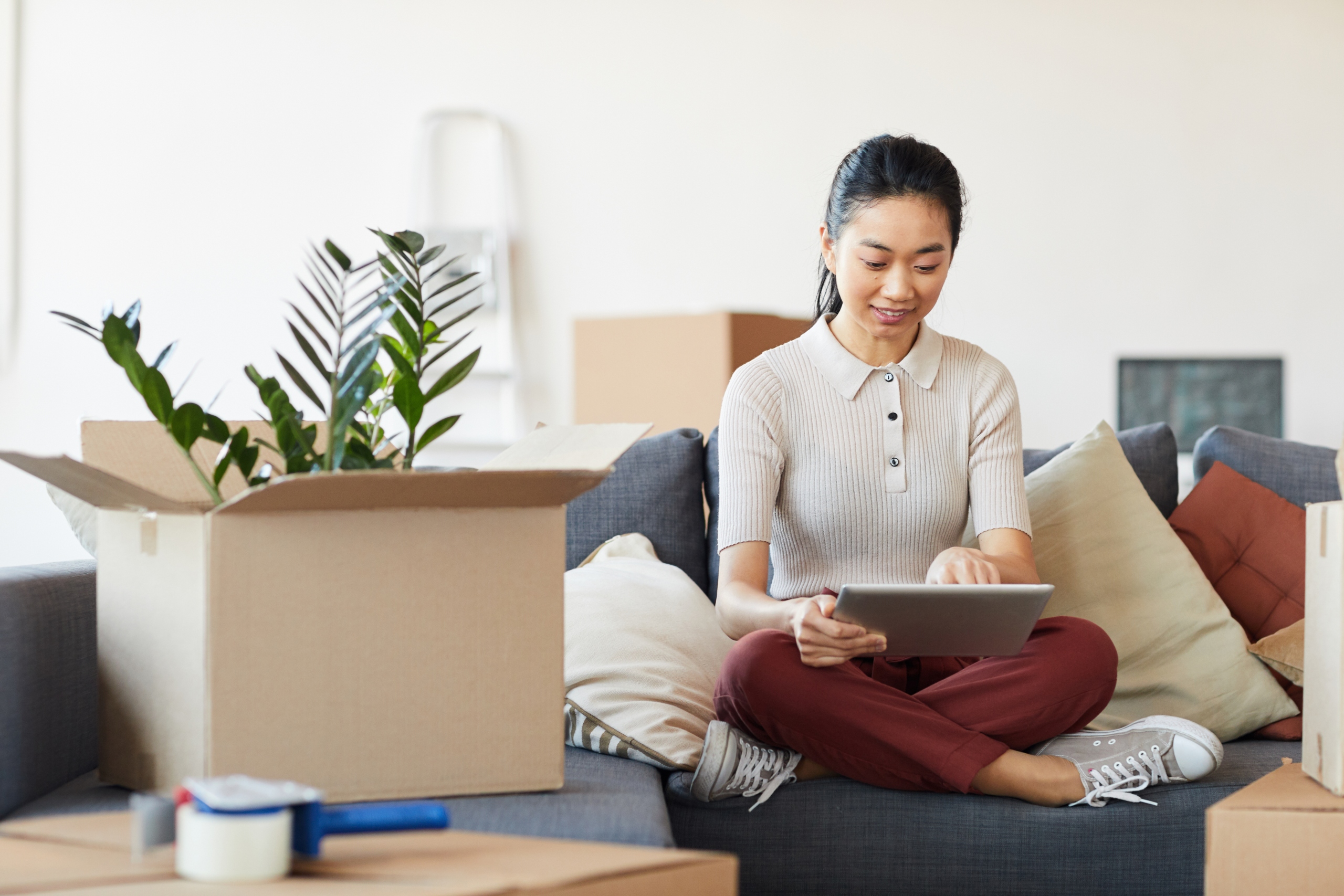 Woman decluttering with boxes around her