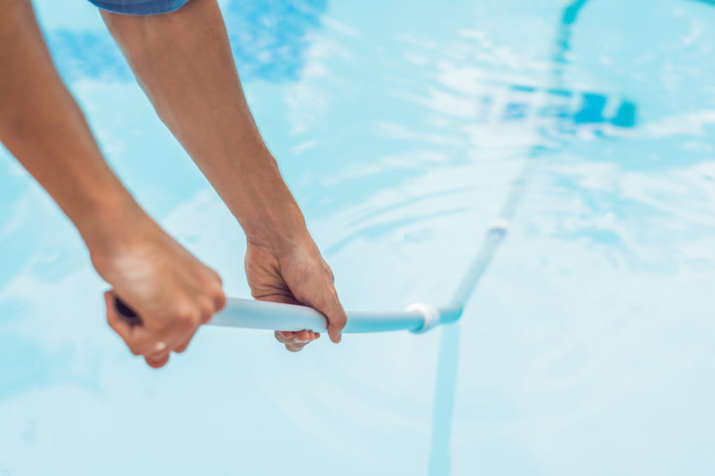 Person cleaning the pool
