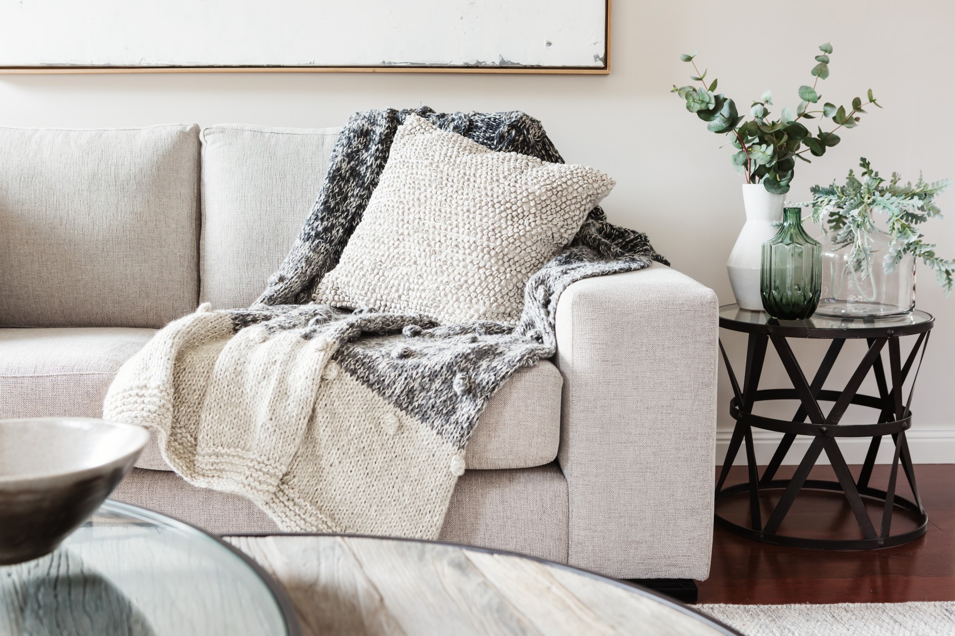neutral couch with textured pillow and throw