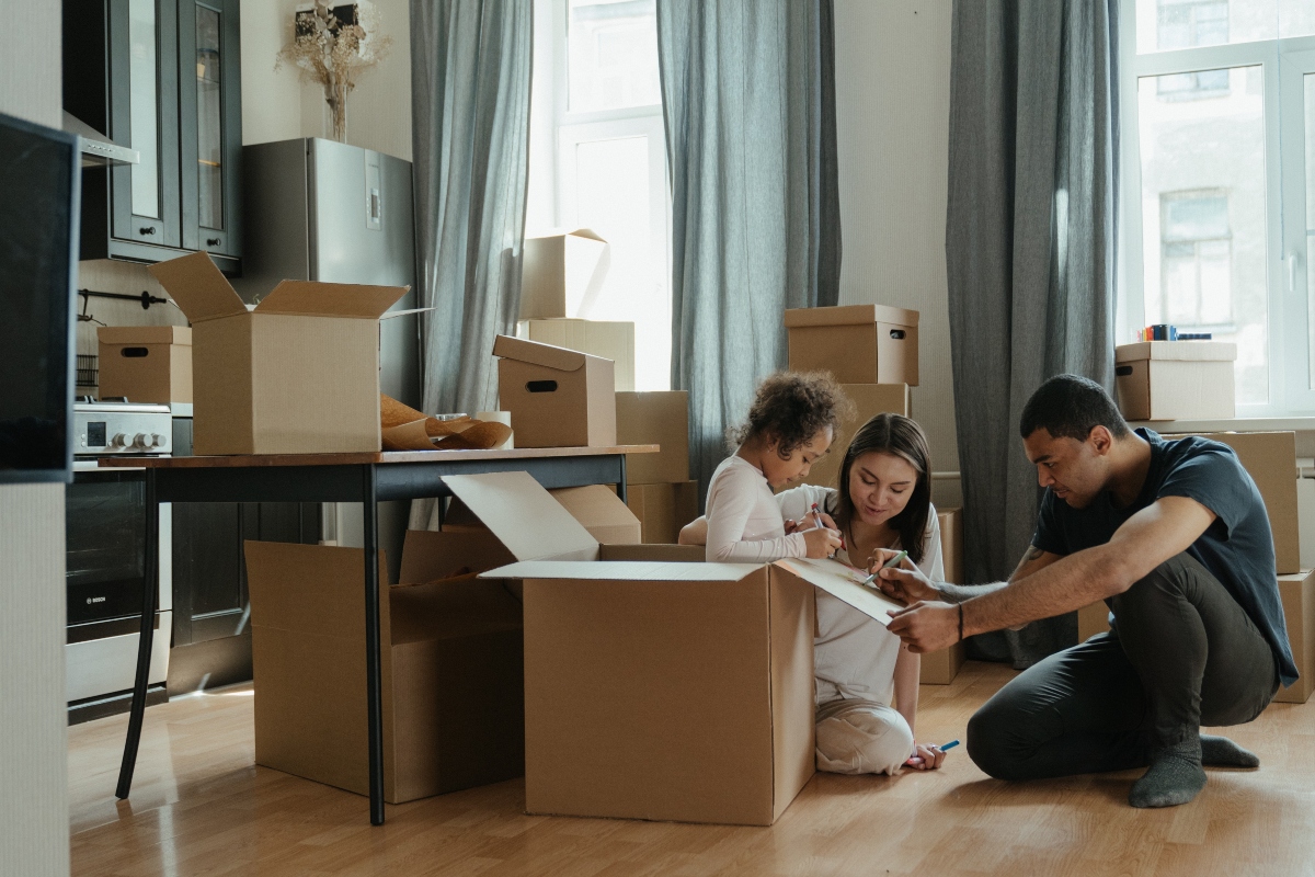 family packing boxes in living room
