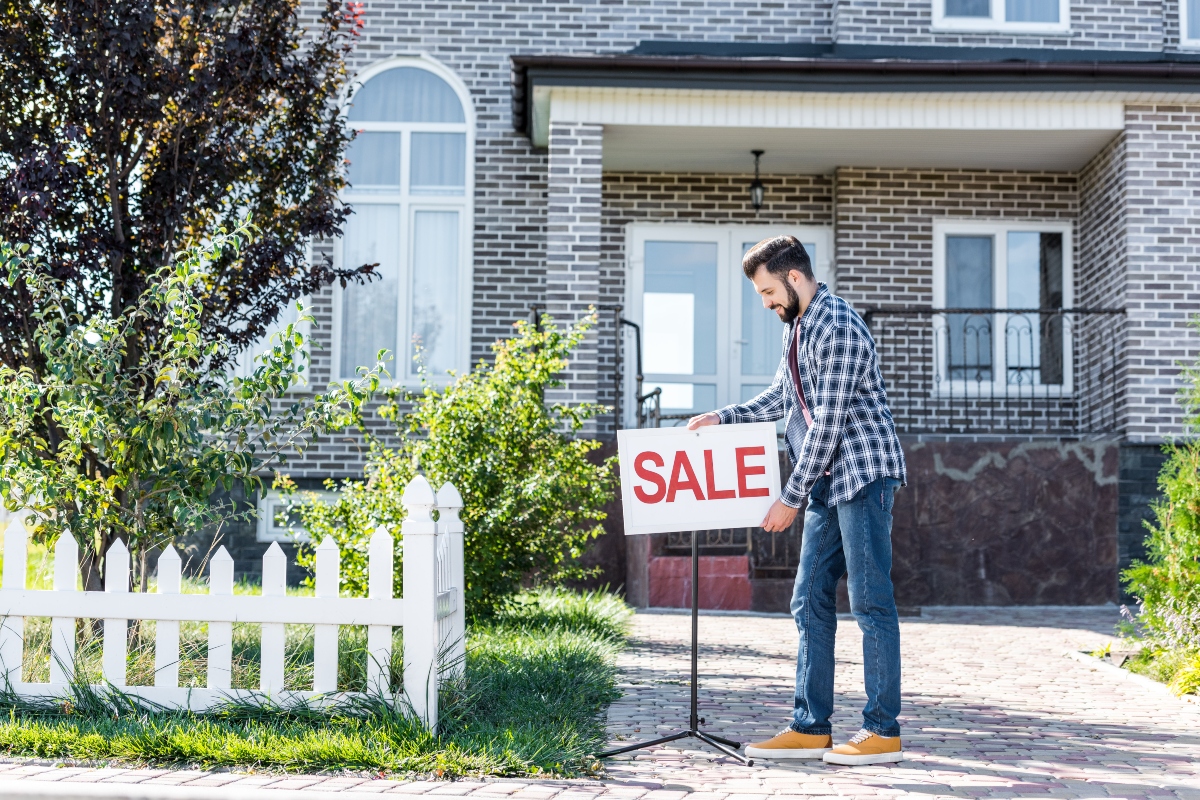 man in front of house for sale