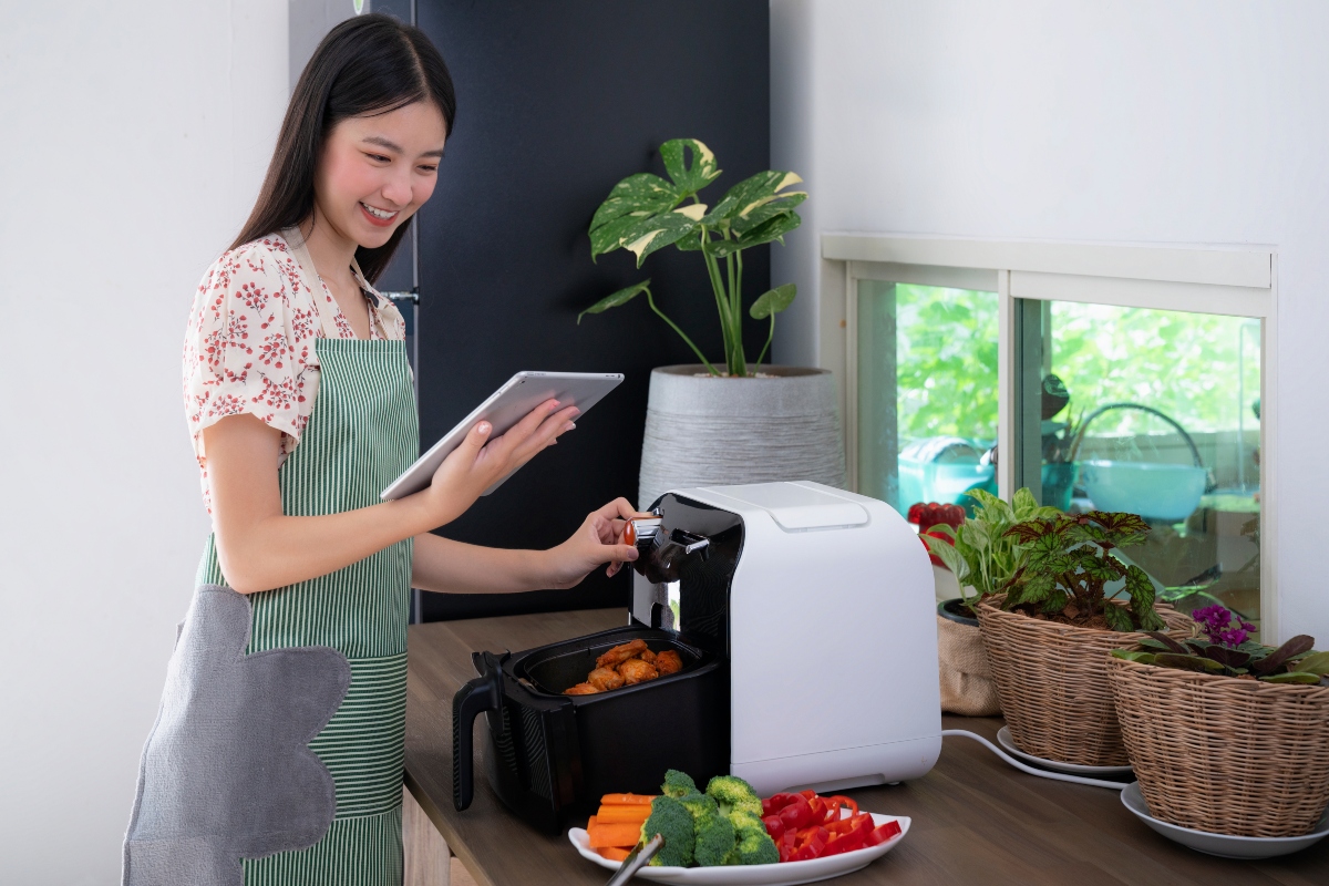 woman cooking with an air fryer