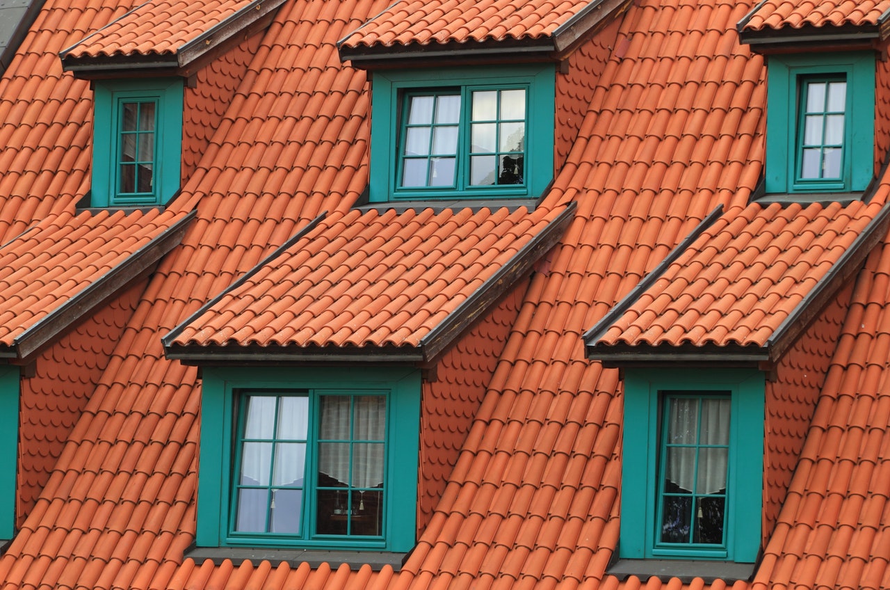 roof with red shingles and multiple windows