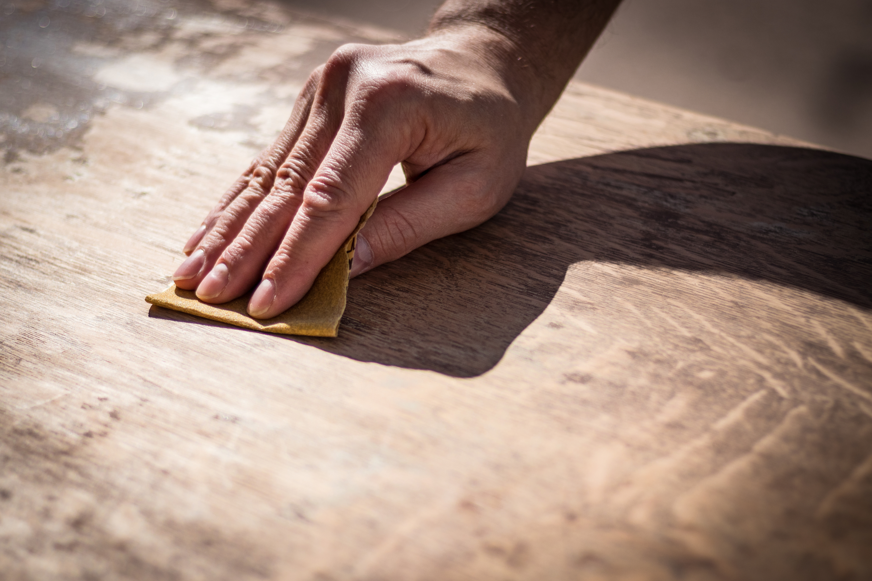 Man's Hand Holding Sandpaper