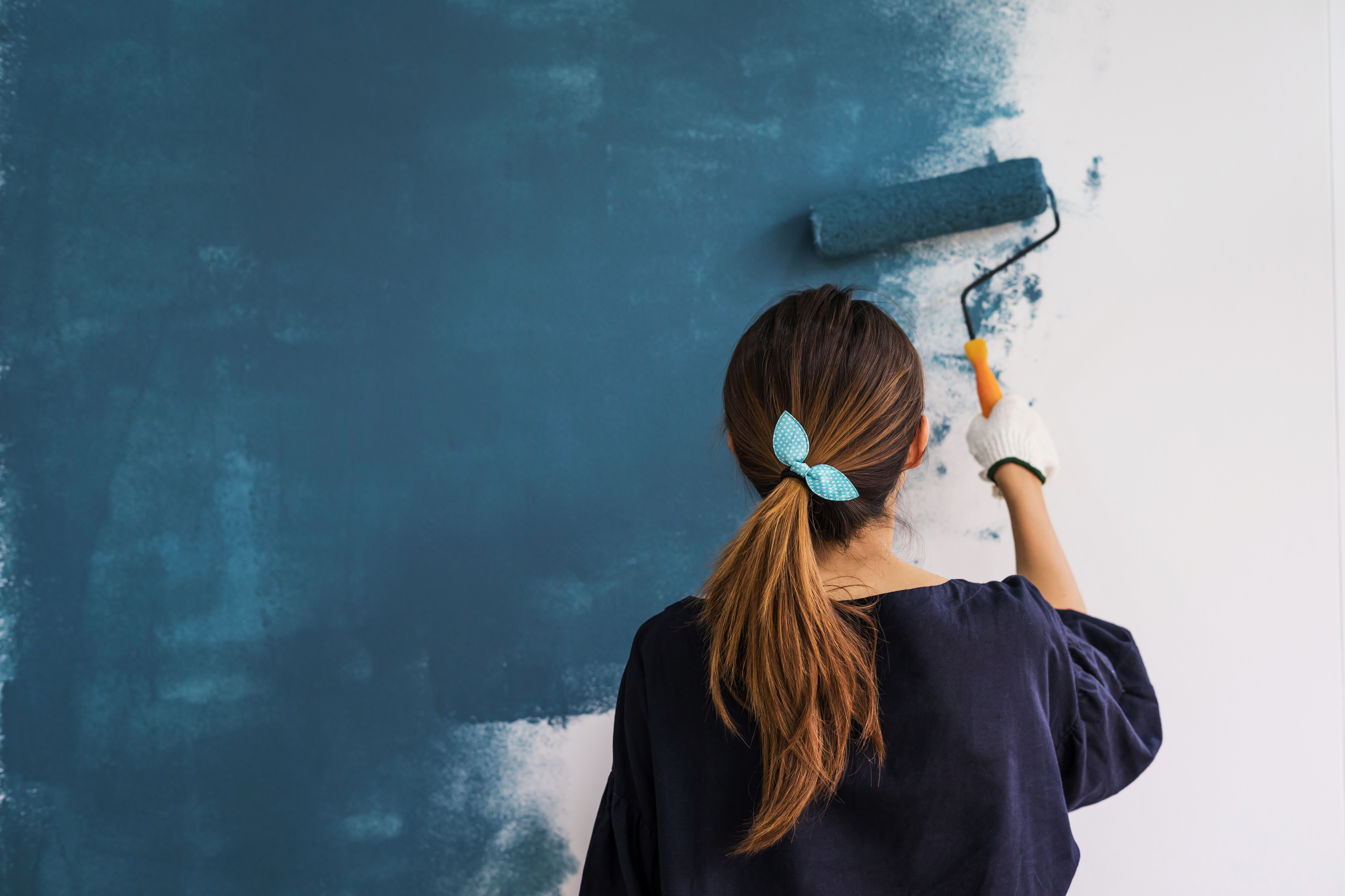 Woman painting with paint roller