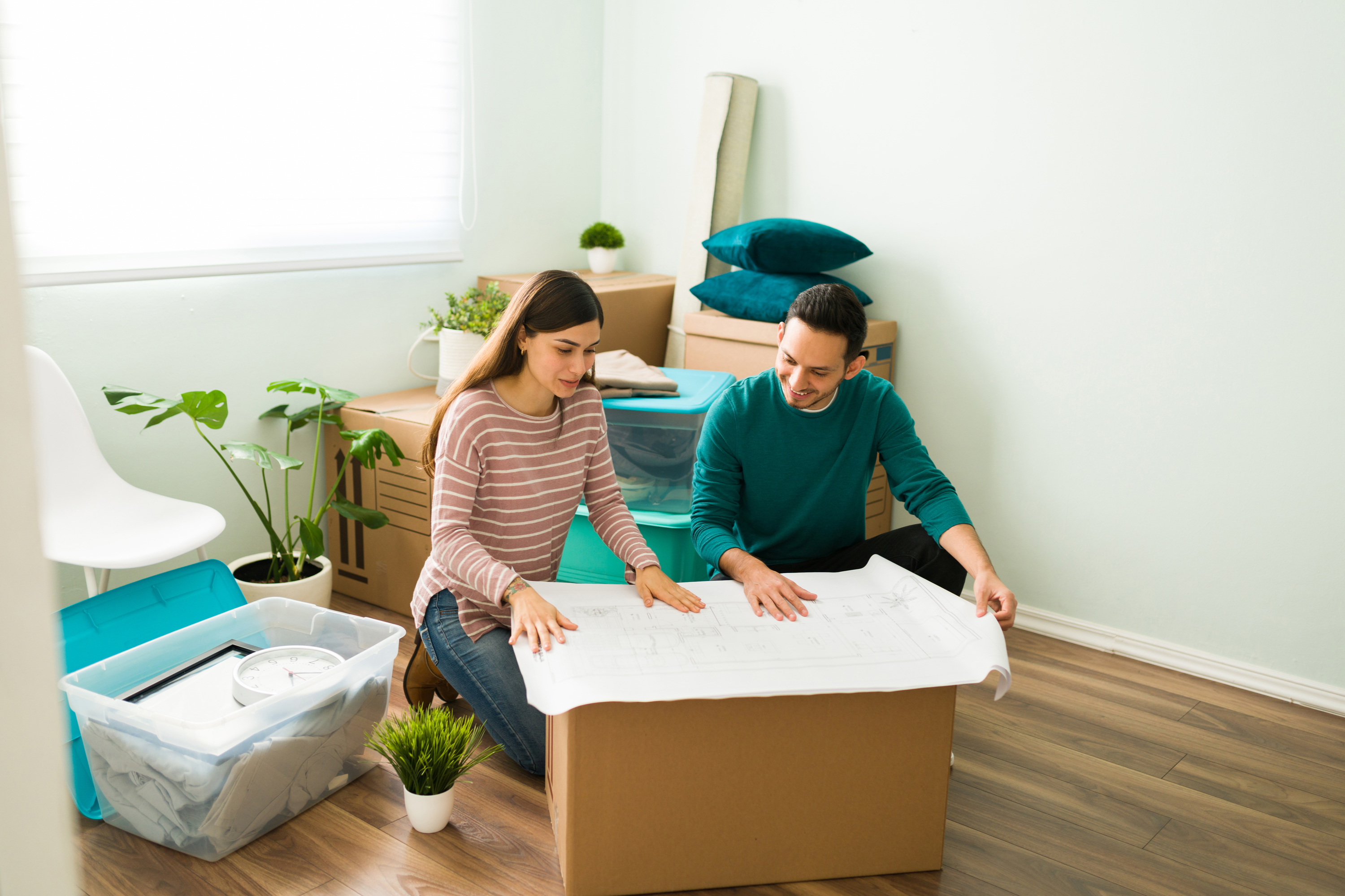 Happy couple looks at bedroom renovation plans