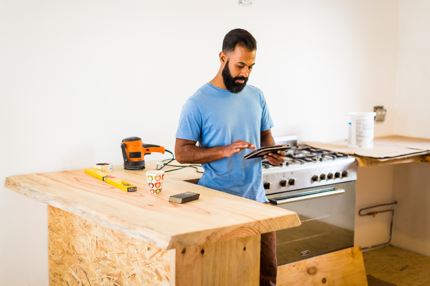 Kitchen renovations with man on a tablet