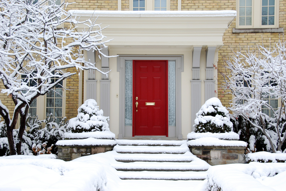 House with red front door in winter