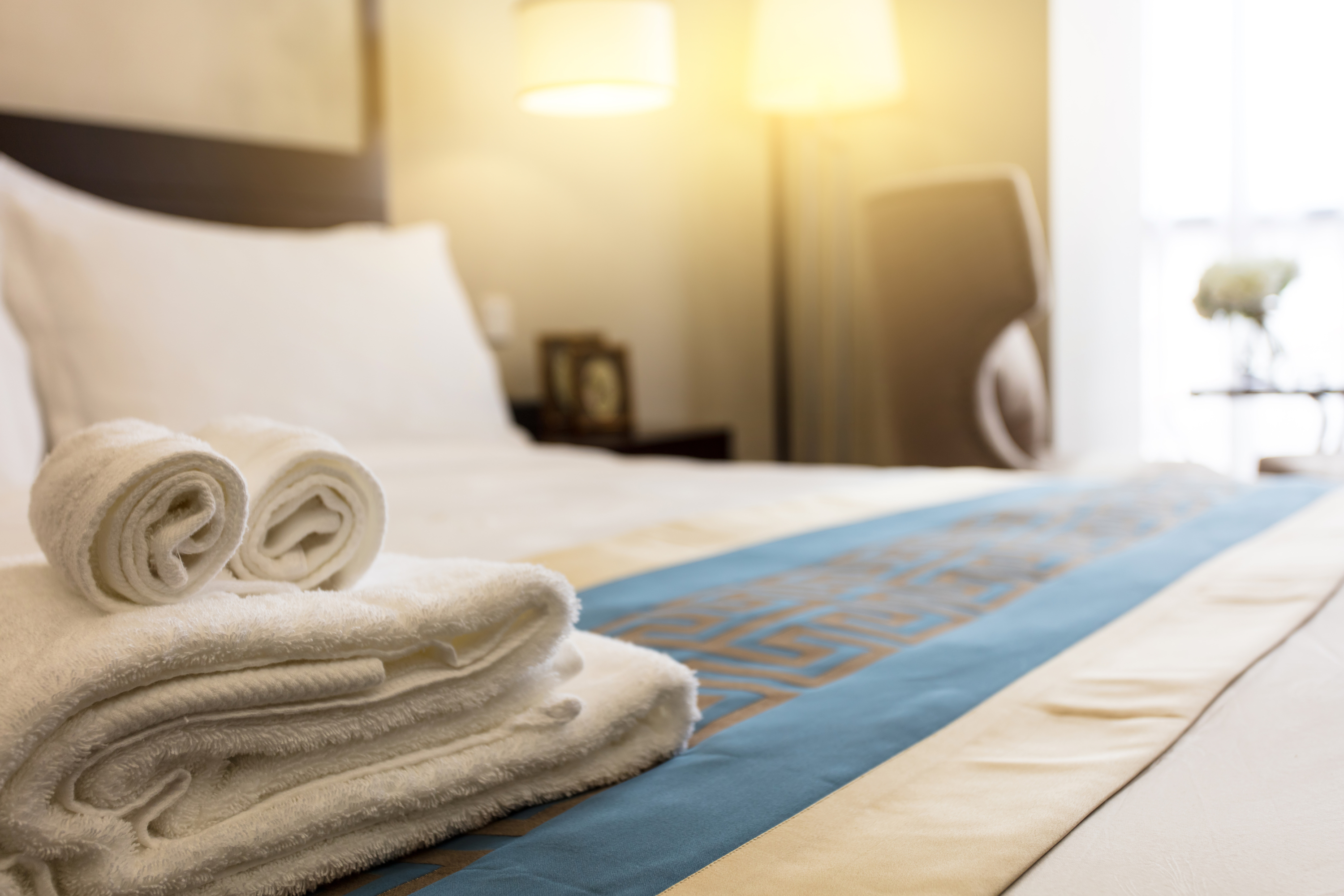 Stack of towels on guest bed