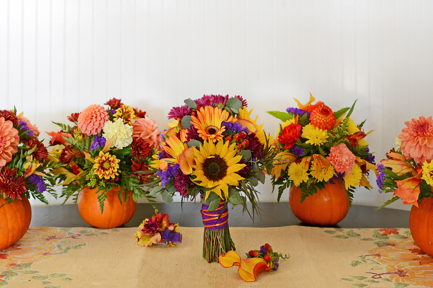 Pumpkins and fall flowers arranged for fall centerpieces