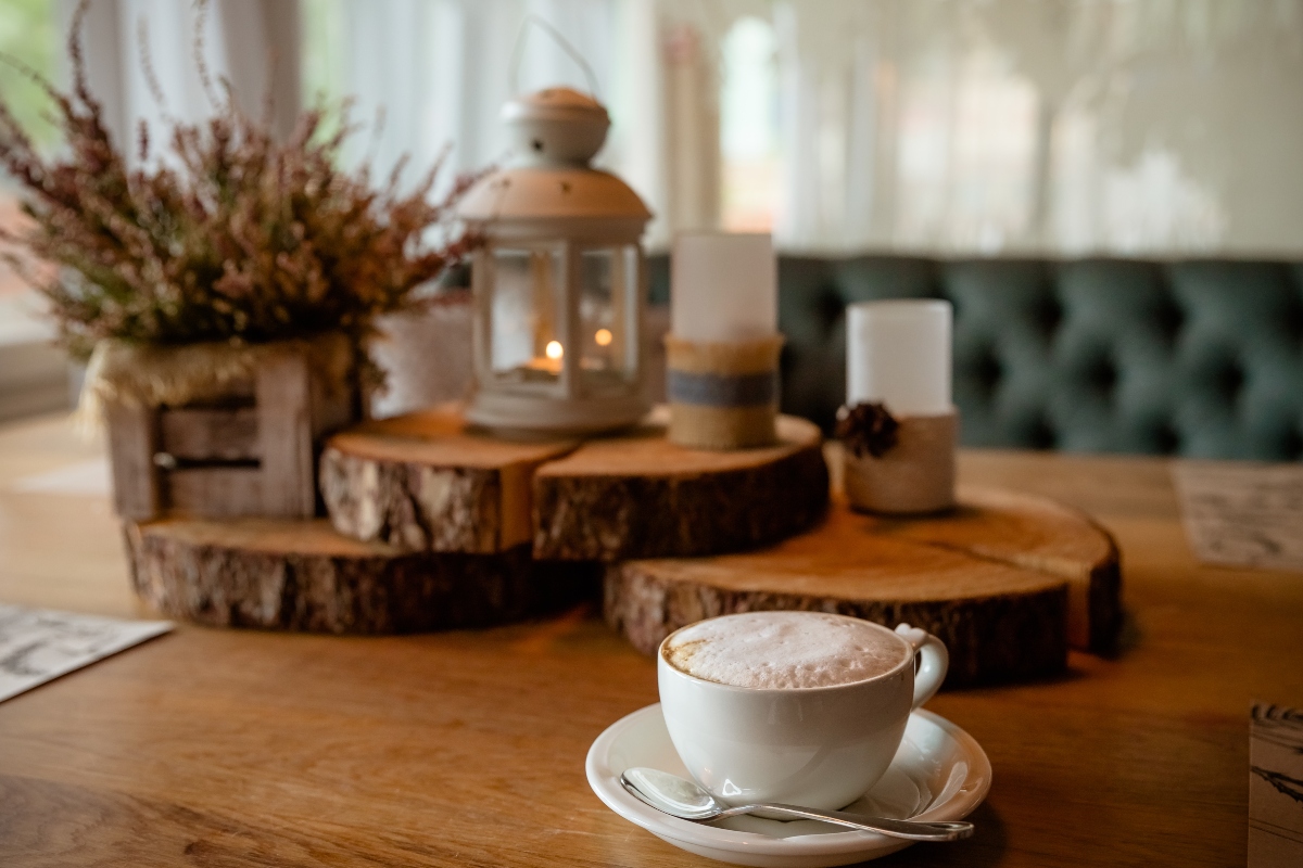 Raw wood with lantern and teacup on a rustic table