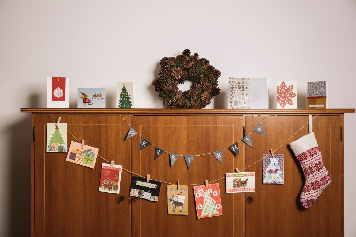 Christmas cards on display with holiday decor
