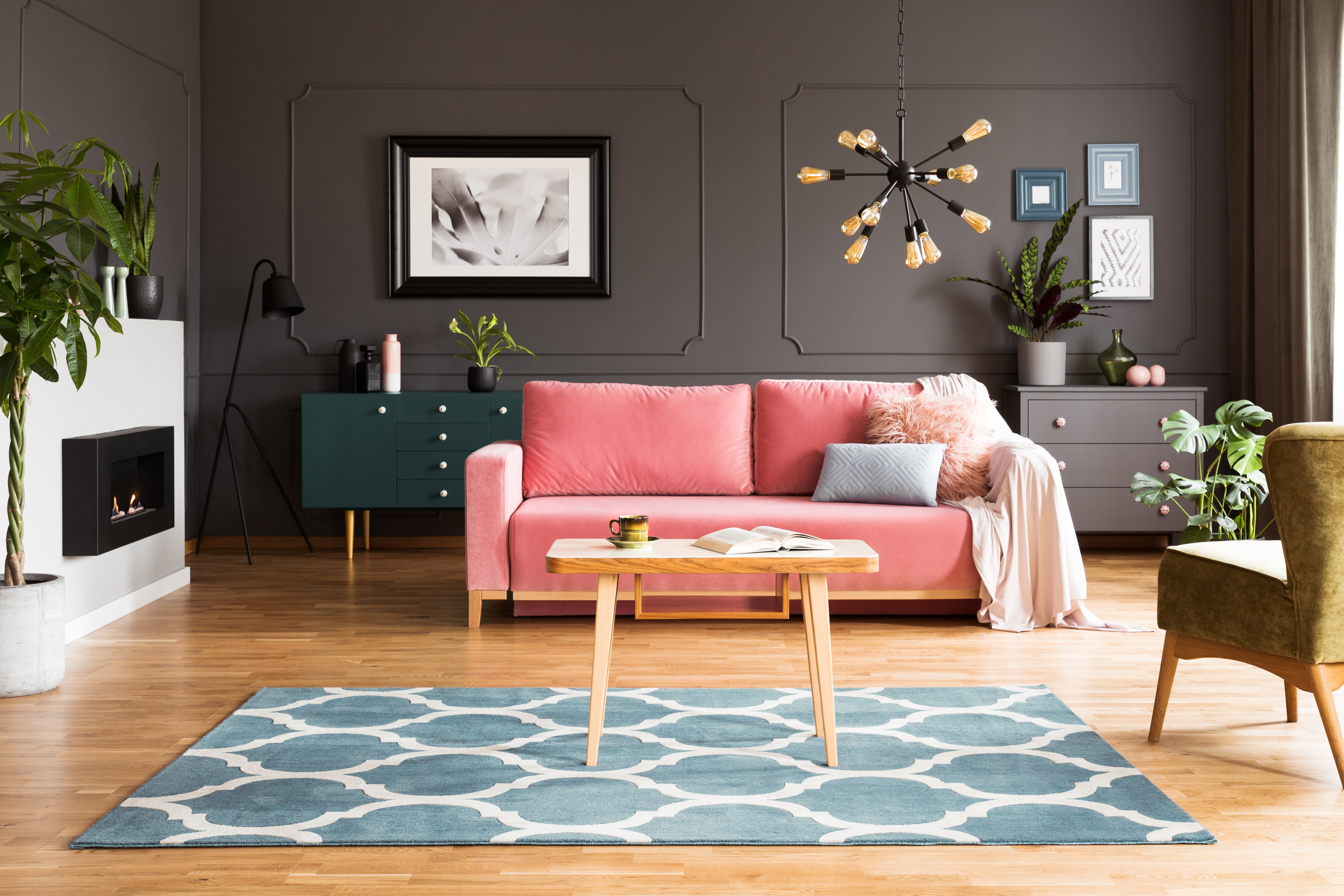 gray living room with pink sofa and blue rug