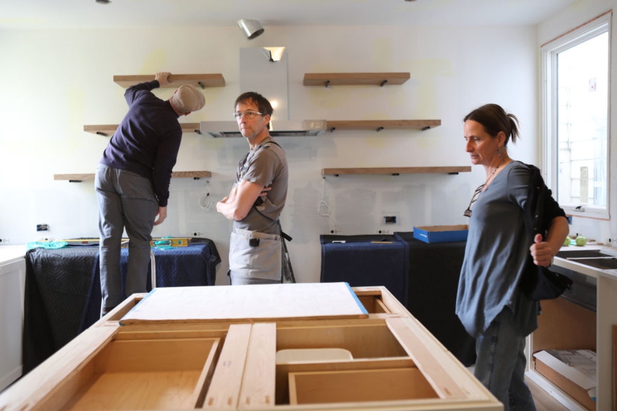 people renovating the kitchen and replacing the cabinets