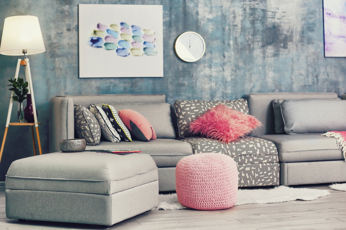 small living room with pink and grey palette and ottoman table