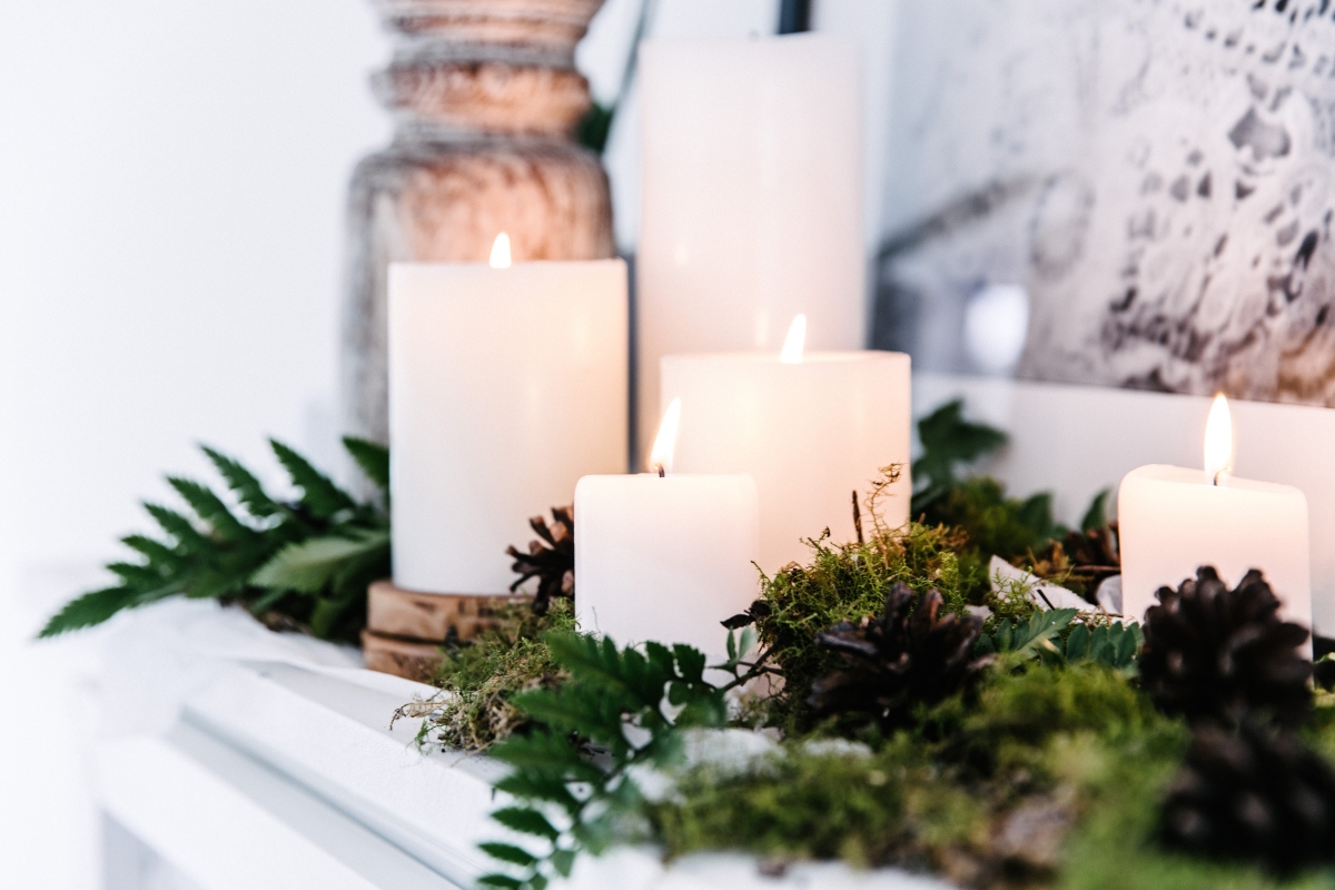 candles and foliage on fireplace mantel