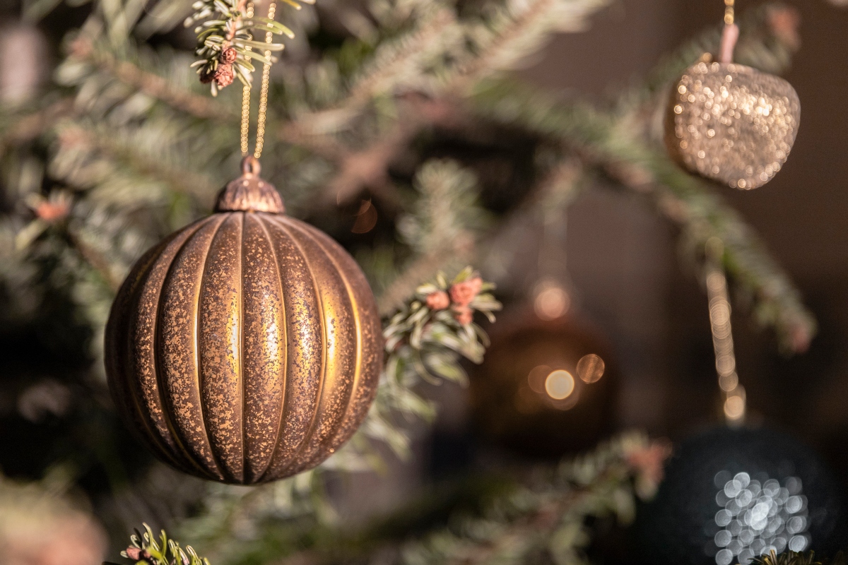 close up view of neutral christmas bulb ornaments on tree