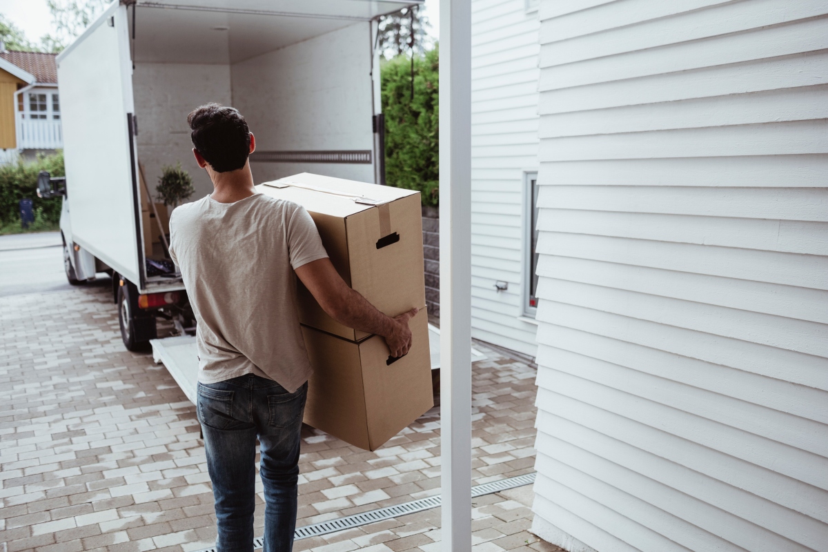 Man carrying boxes to a moving truck