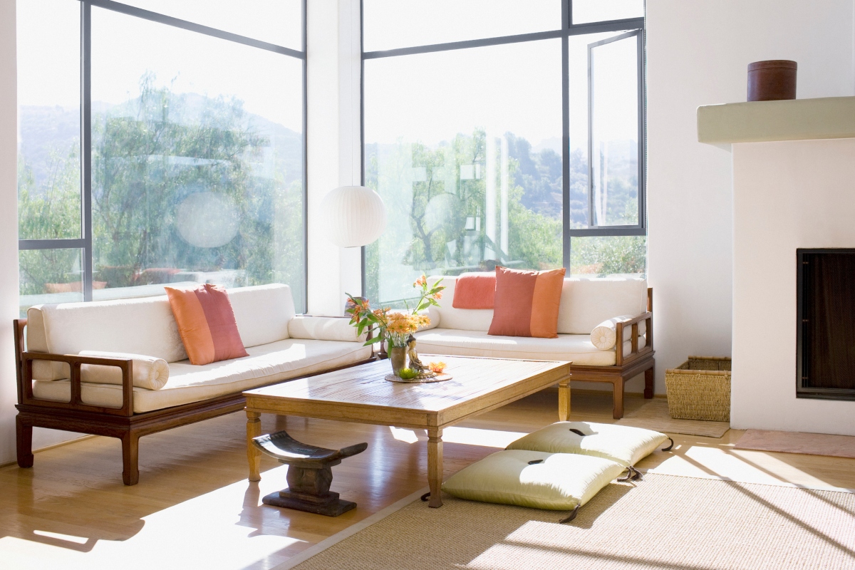 minimal and modern living room with wood coffee table and pink cushions on sofa