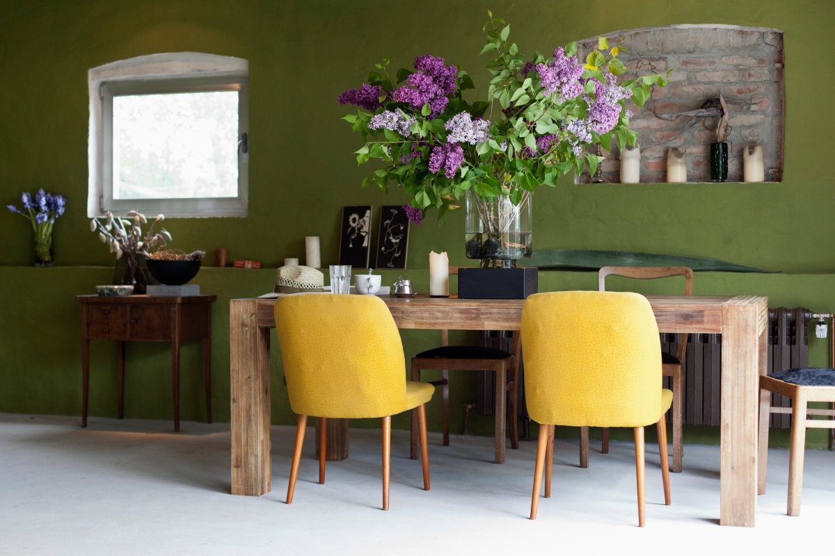 green dining room with yellow chairs