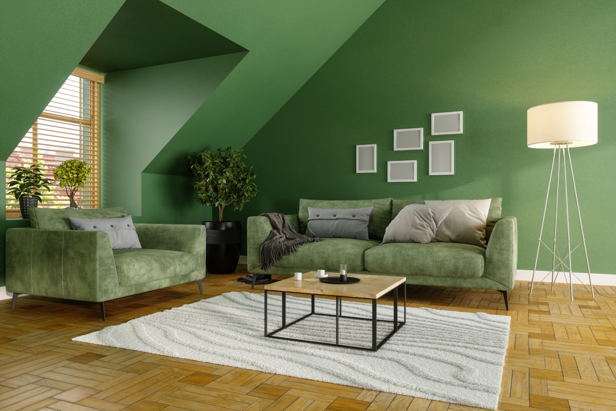 Green living room walls with velvet green sofas