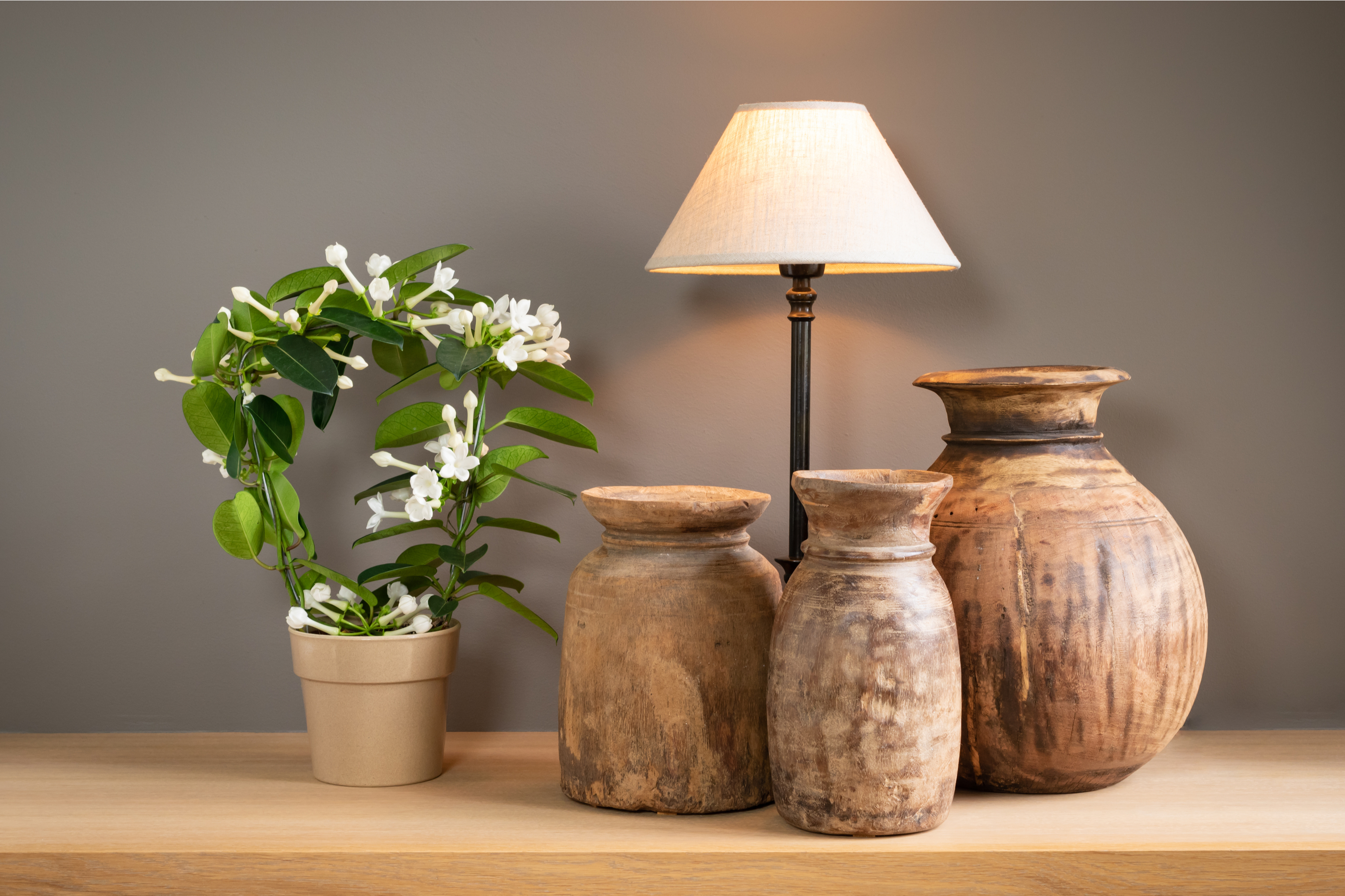 Clay pottery vases beside lamp on table