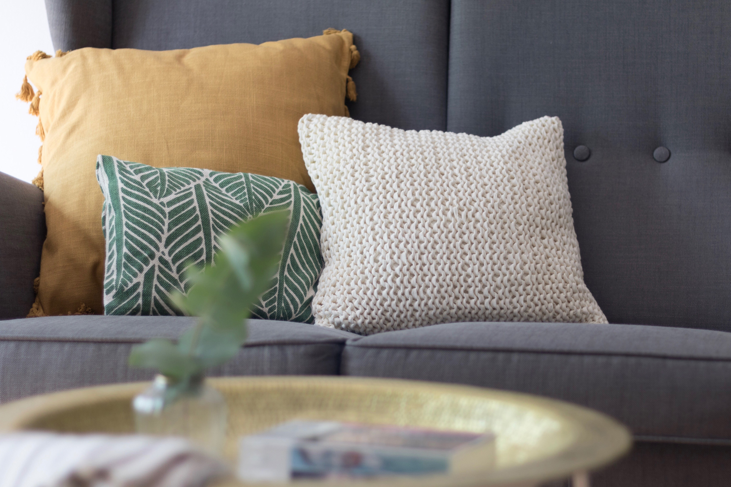 Three throw pillows on a sofa