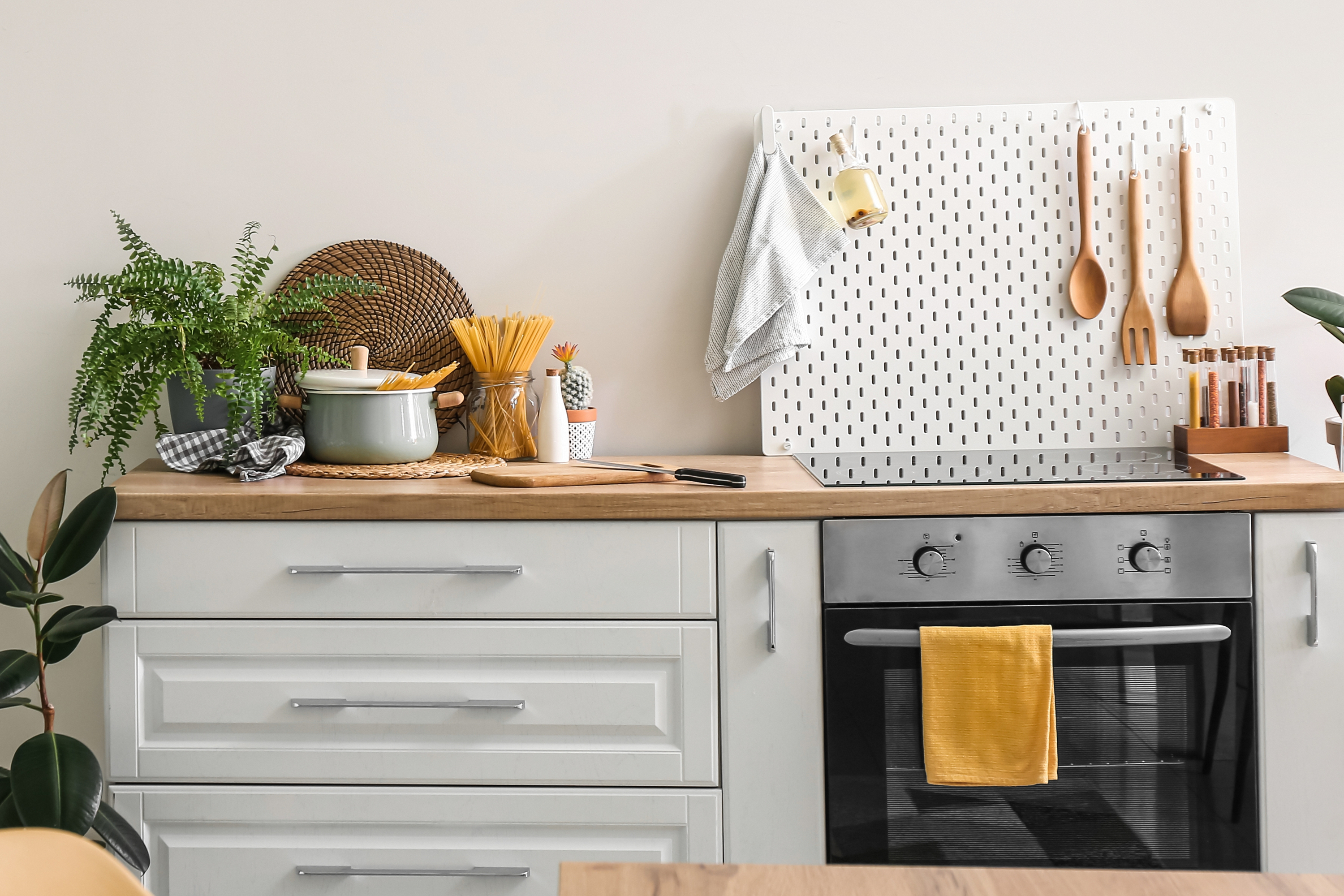 small kitchen with wood countertop and pegboard wall