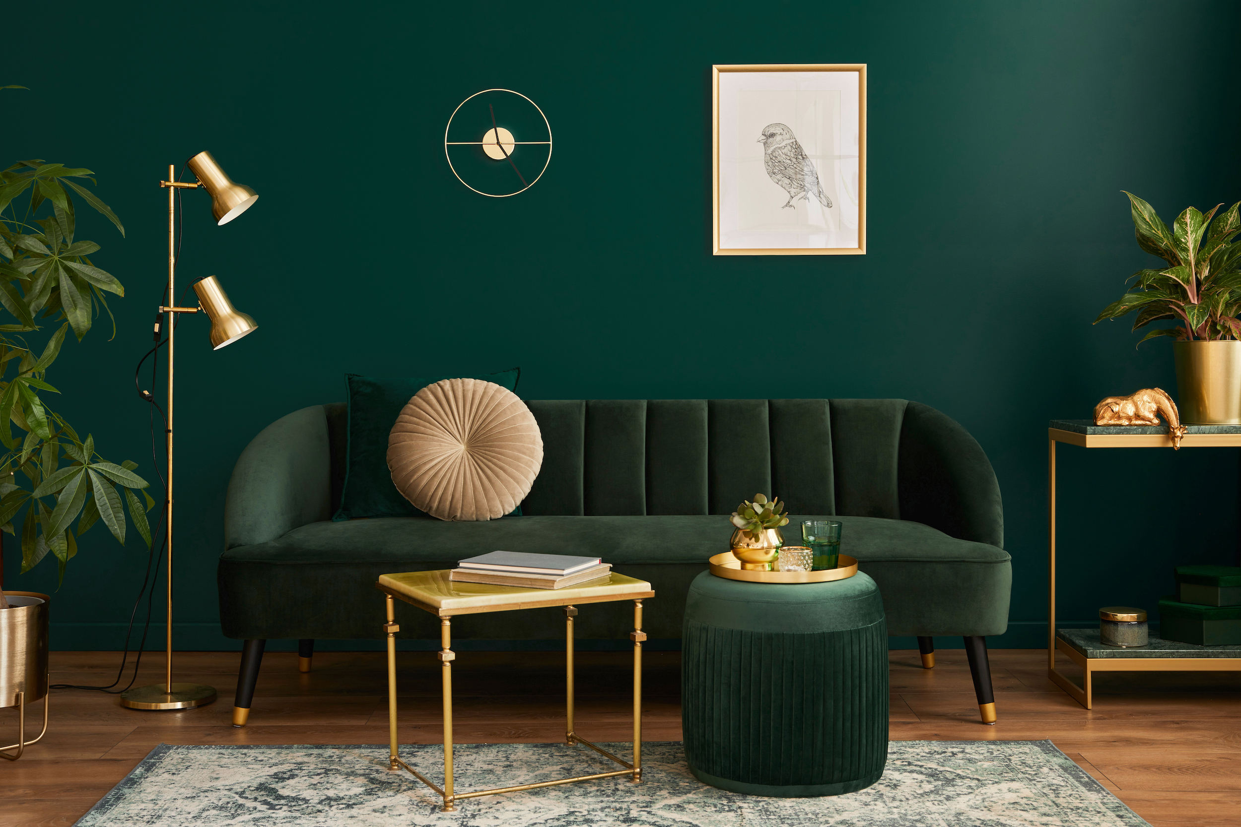 Living room with dark green walls and couch.