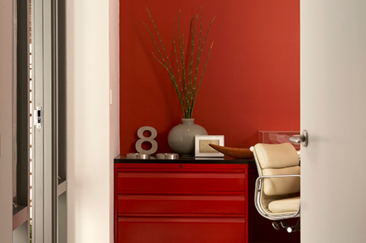 red office accent wall and dresser