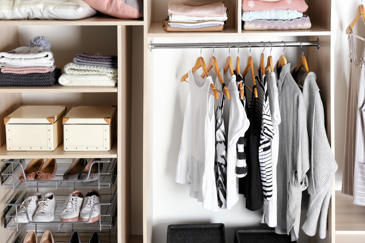 closet with built-in storage and drawers for saving space with folded clothing