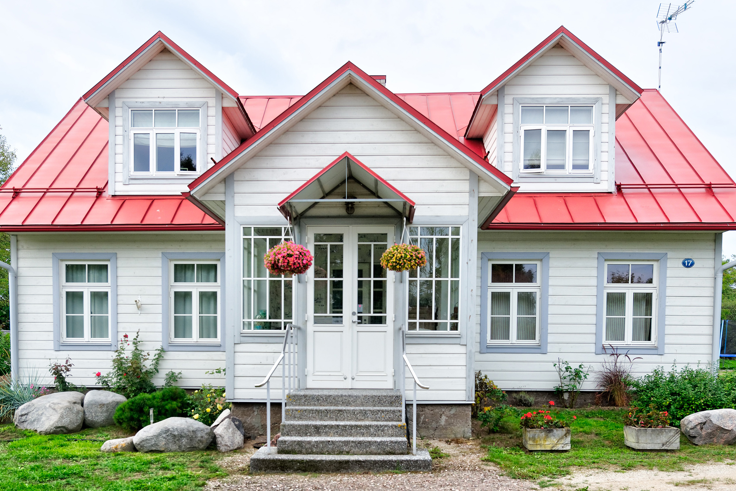 White Cape Cod style house with red roof