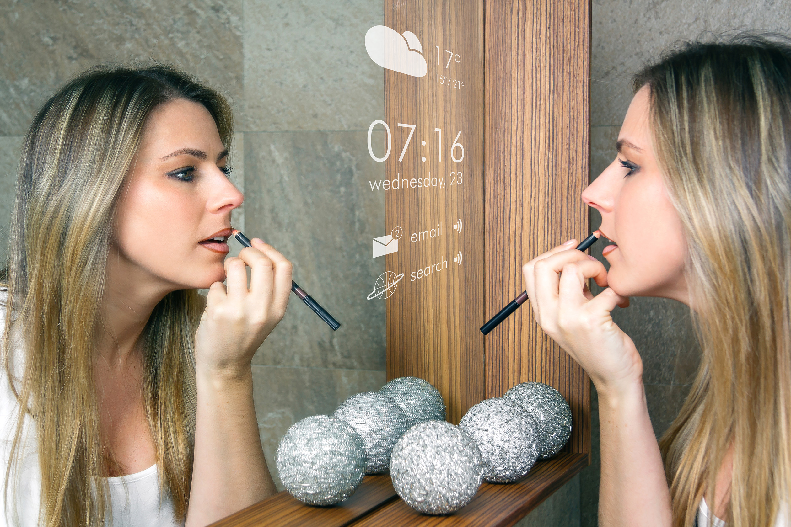 Woman putting on makeup in a smart mirror