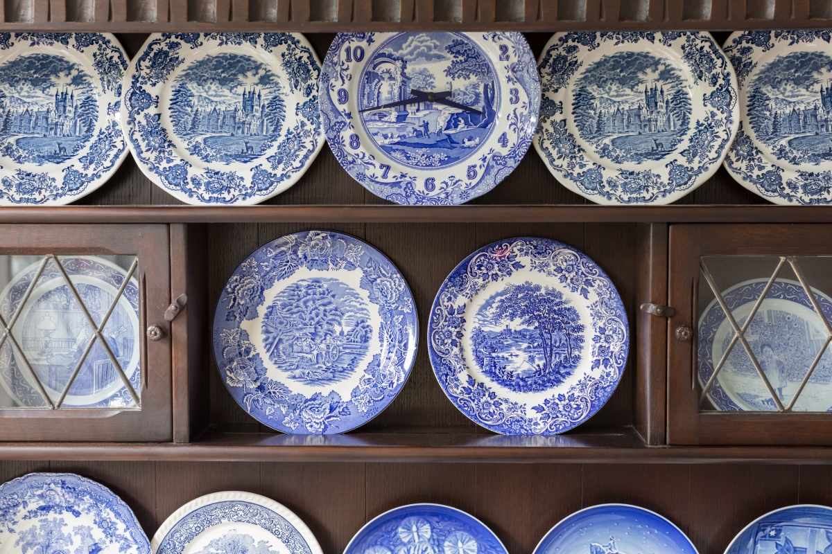 china cabinet with blue and white ceramic plates on display