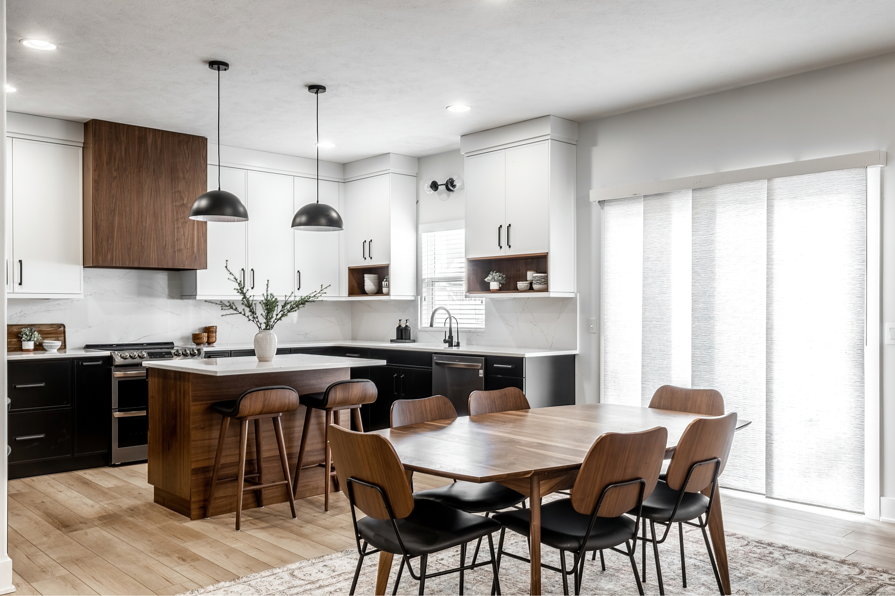 Kitchen with black cabinets and dark wood inspired by midcentury design