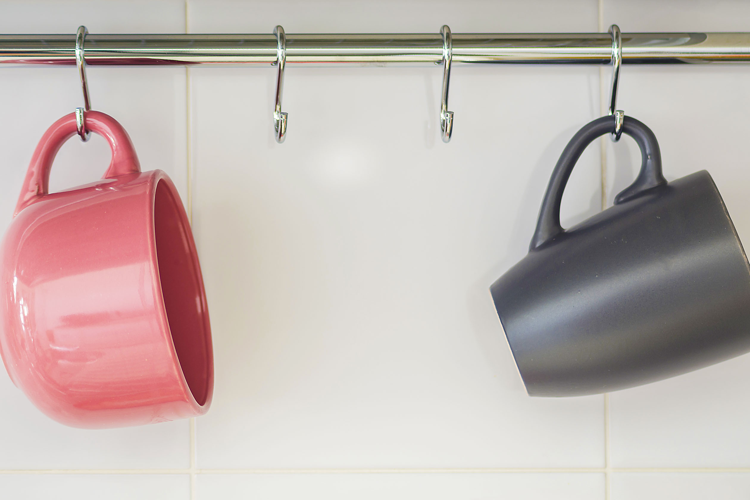 Two mugs hanging on a rack