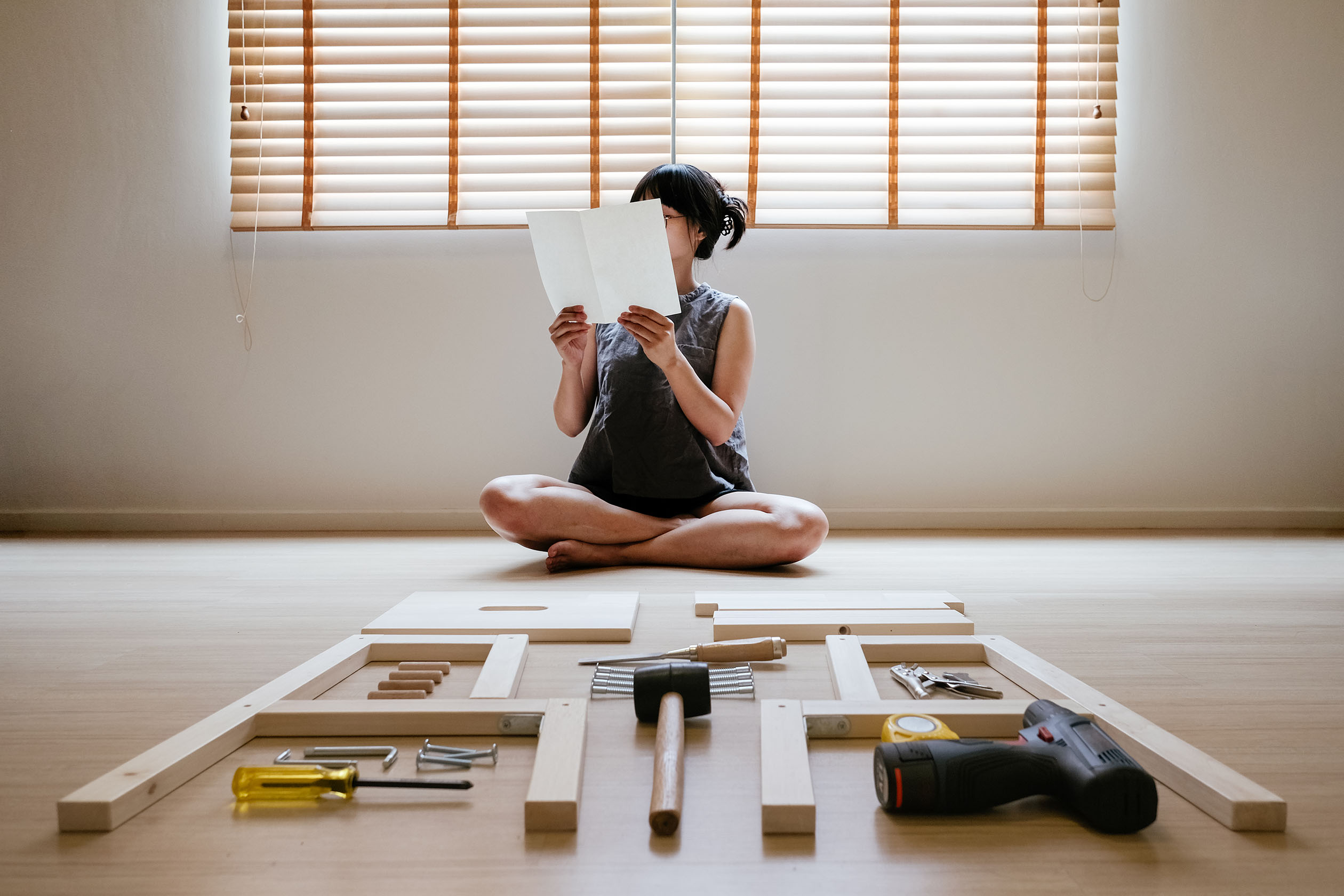 Woman reading furniture instructions