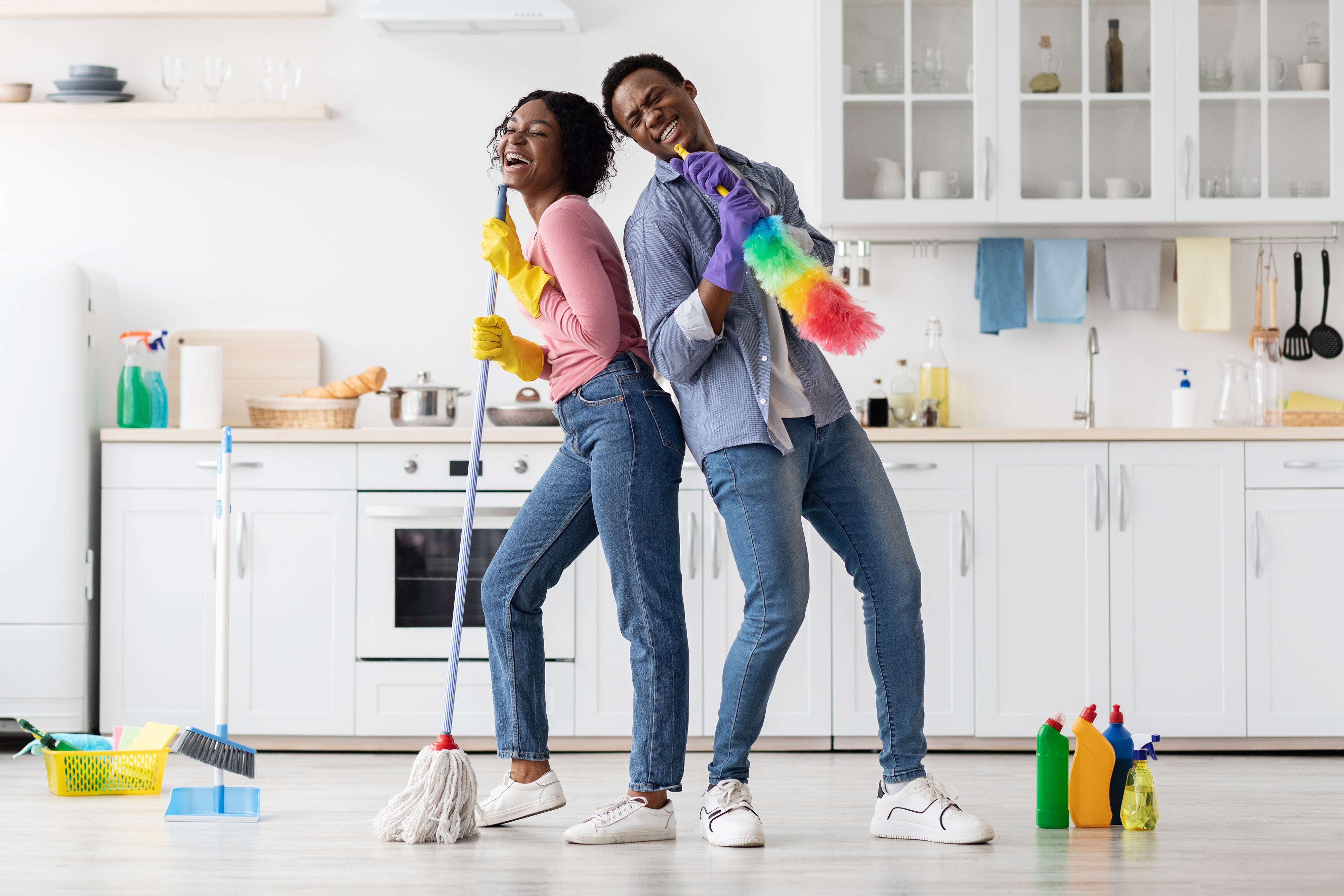 Family pretending to sing with cleaning equipment