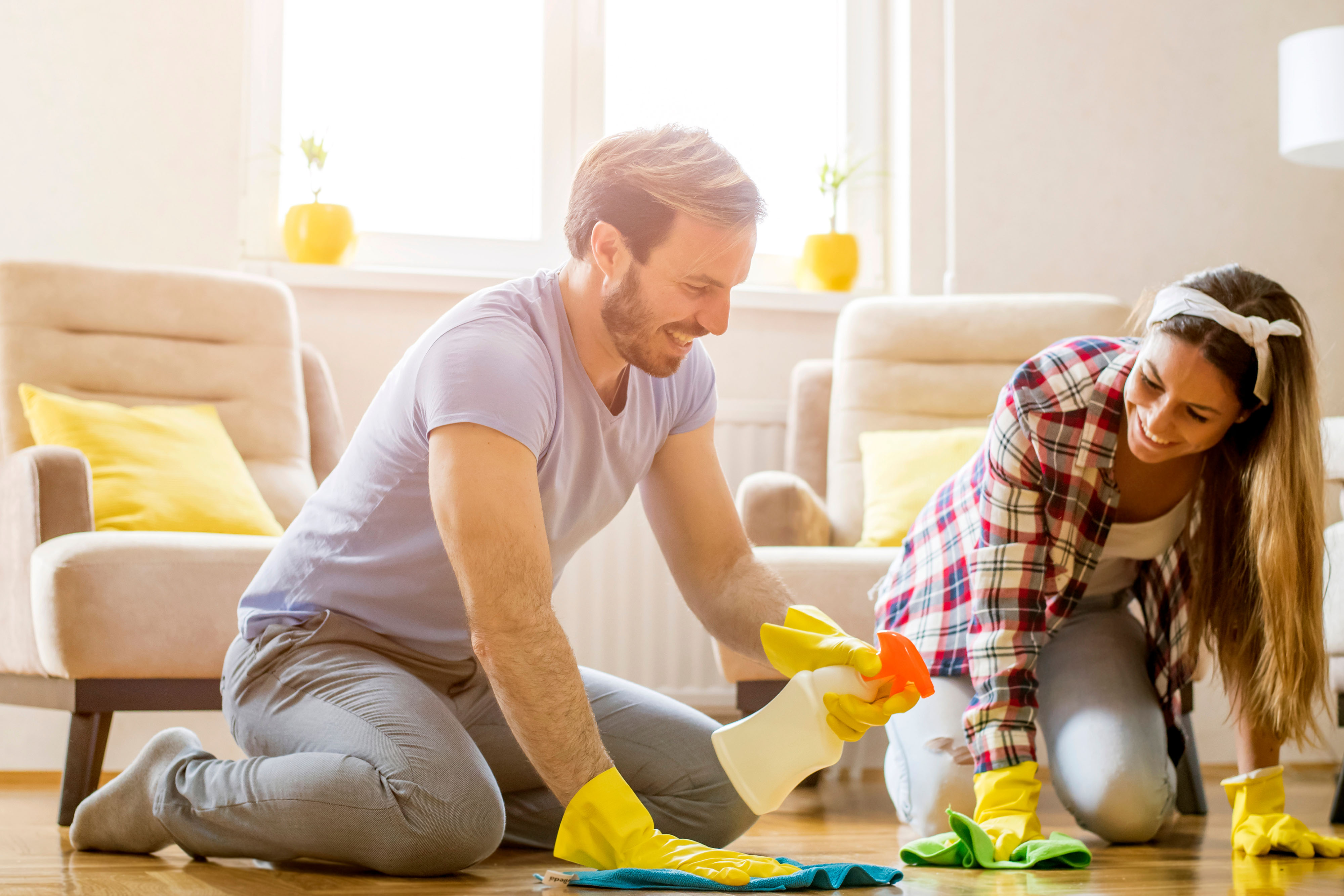 Young couple cleaning the floor together