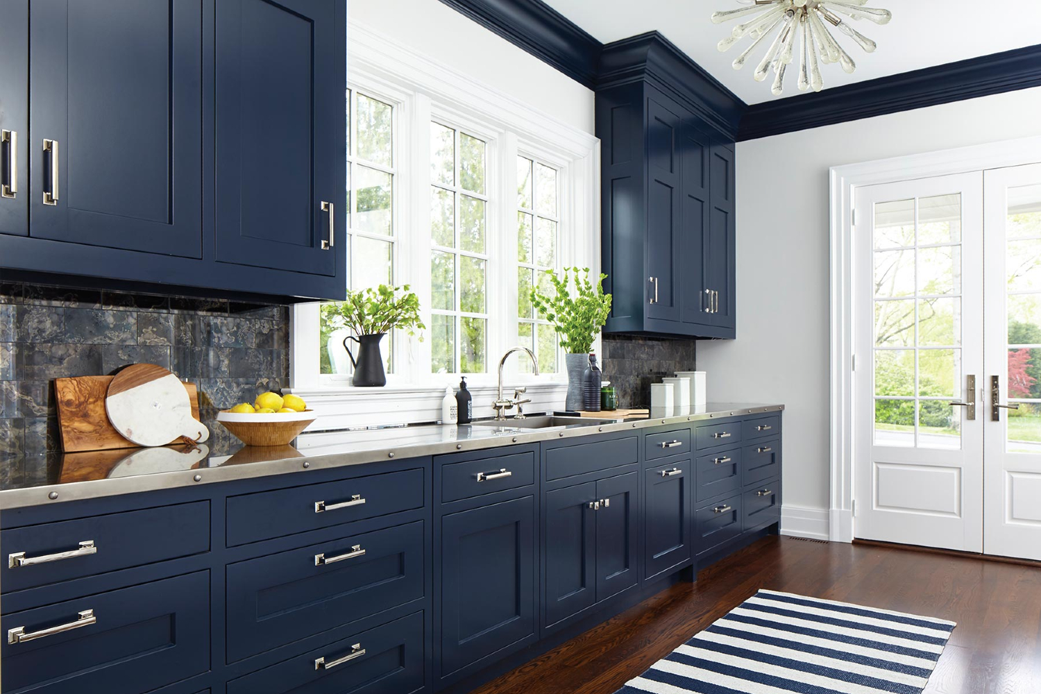 Kitchen with navy blue cabinets and brass hardware