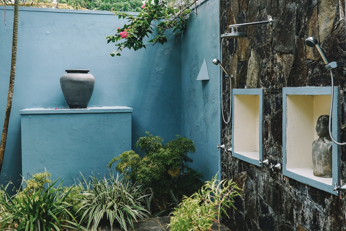 Blue outdoor shower with tile and statues