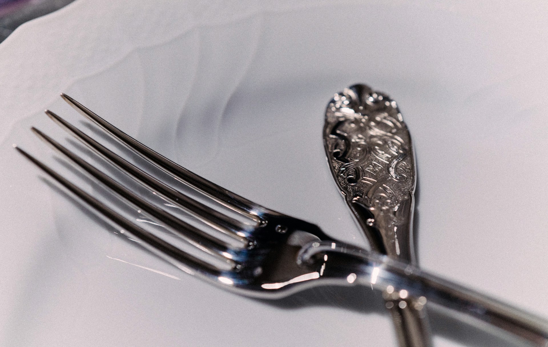 set of silverware on a white plate