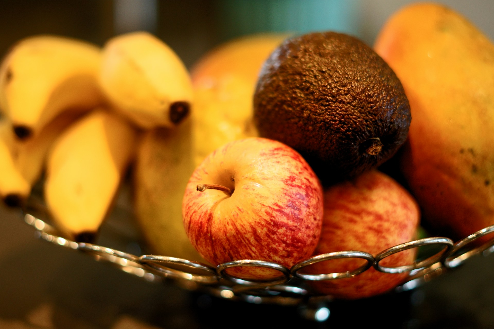 apples and other fruits stored in a metal basket