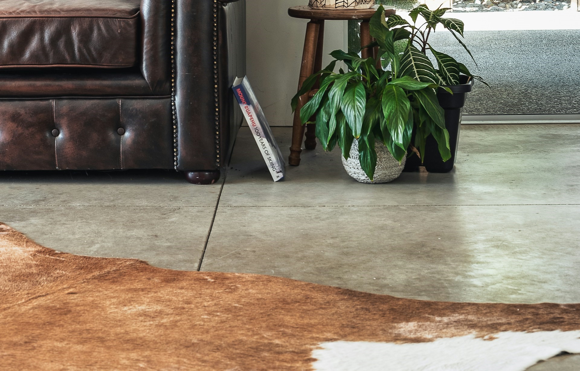 Polished concrete floor with leather furniture and animal skin rug