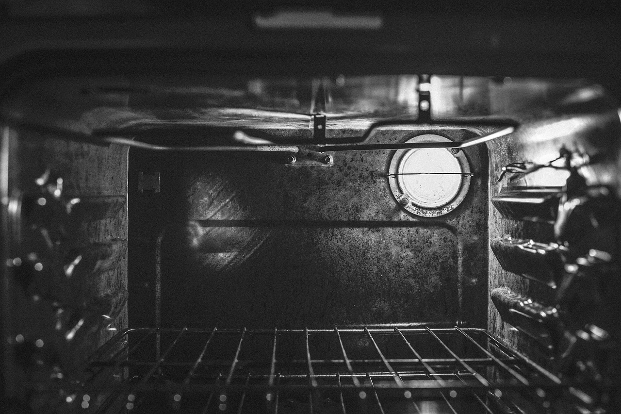 inside of a black oven with oven racks