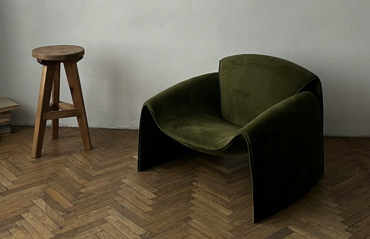modern green chair and stool on classic parquet flooring