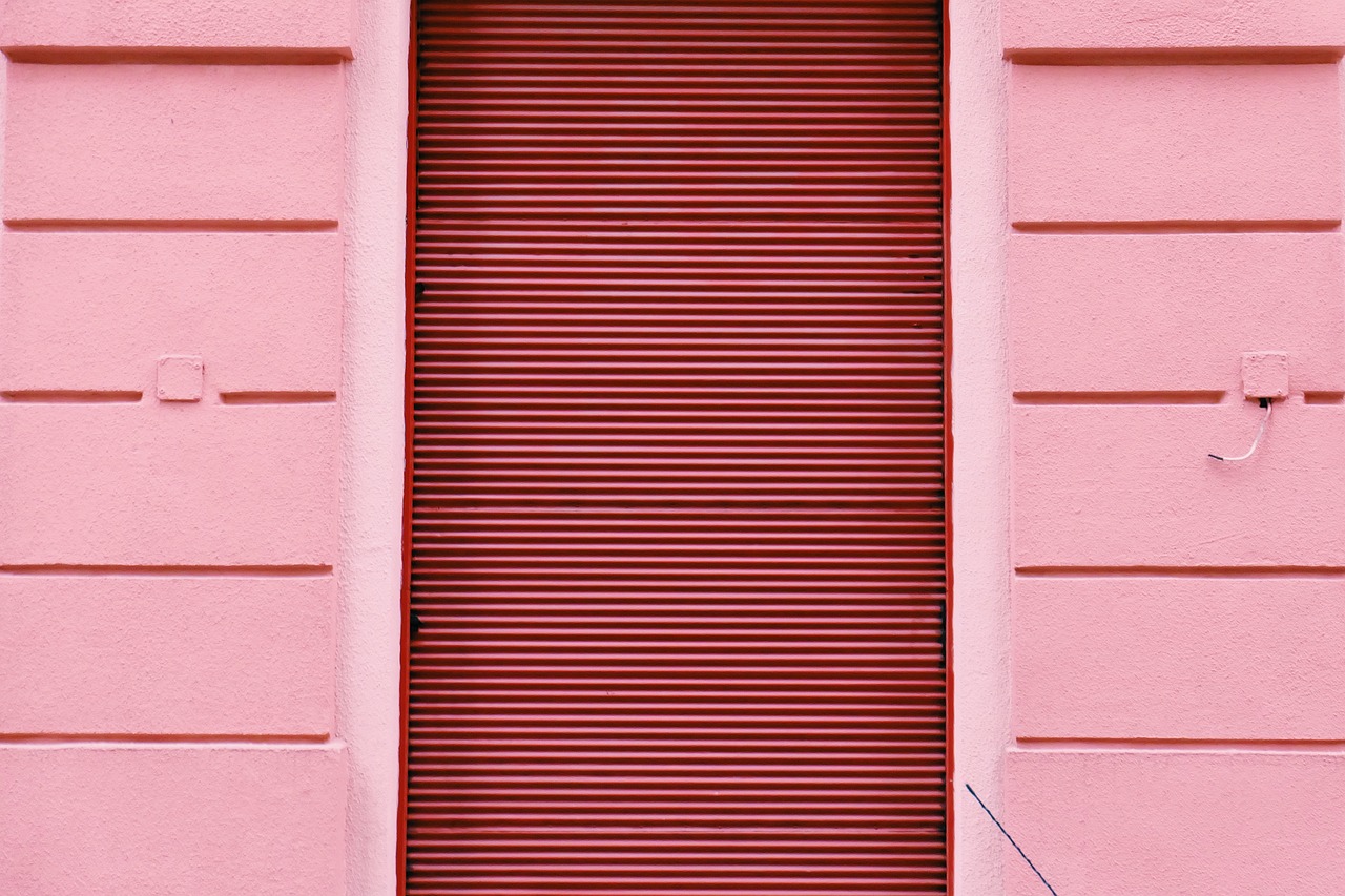 pink siding around a window with pink blinds