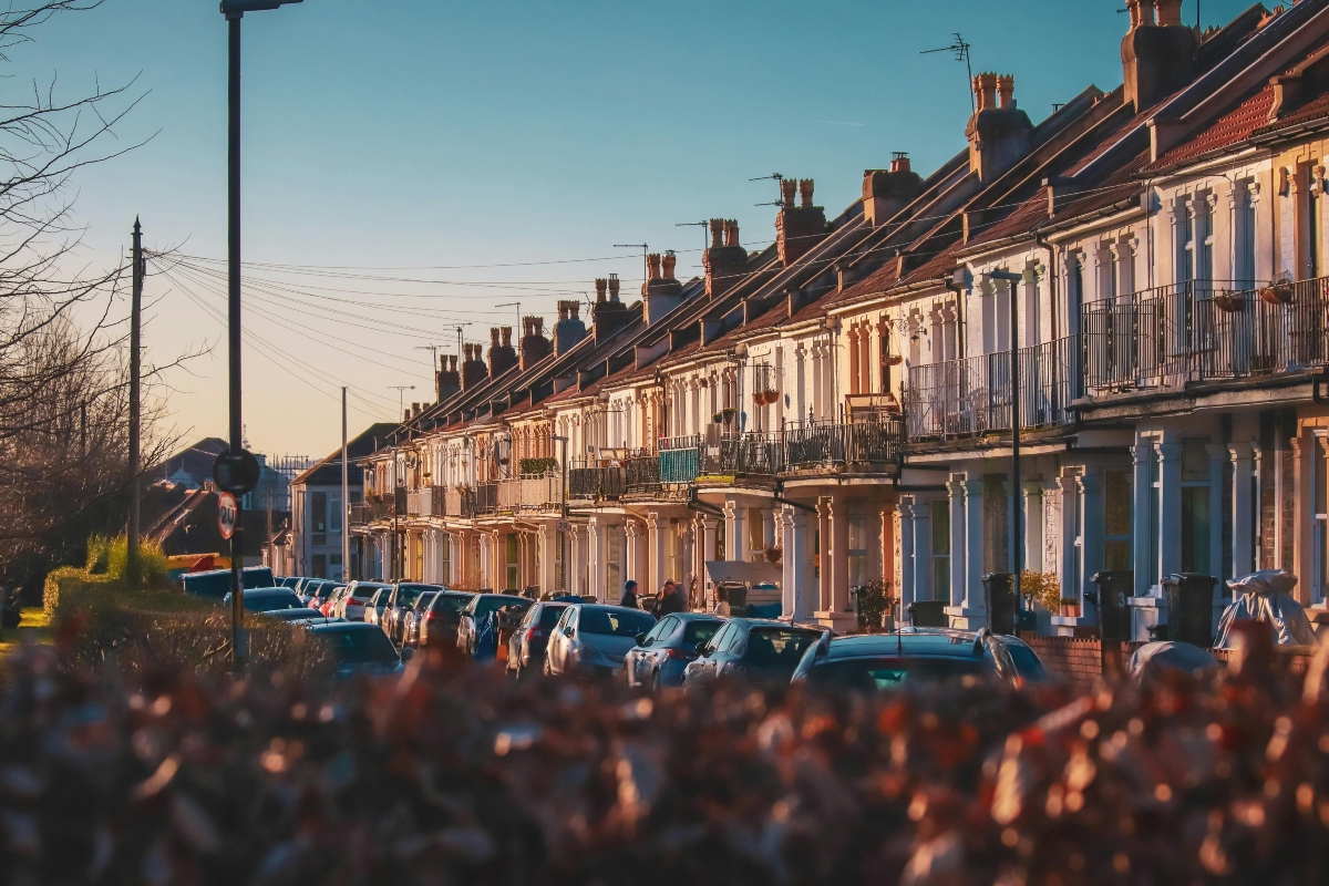 townhouses in a row on a street during sunset