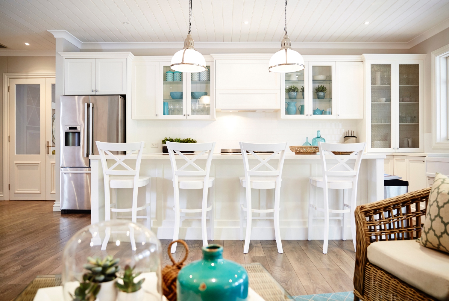 all white coastal kitchen with beadboard ceiling
