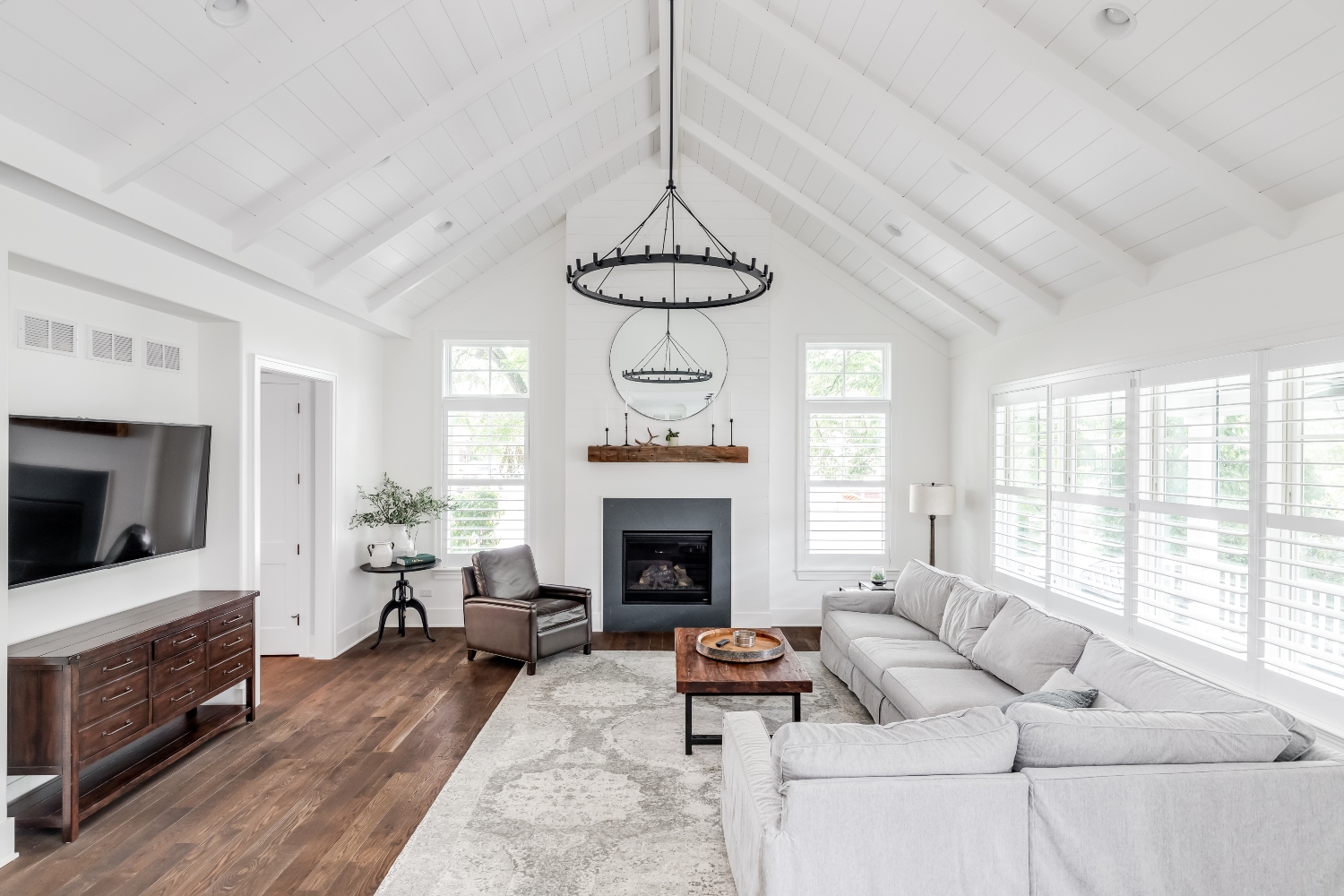 All-white modern farmhouse living room with a beadboard ceiling
